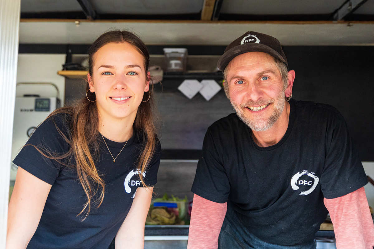 Two food truck vendors smile for the camera