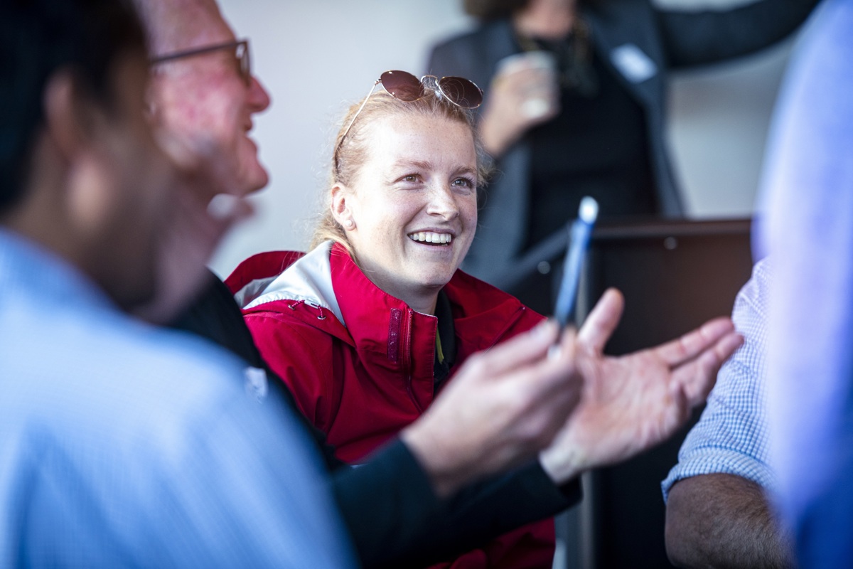 A young businesswoman smiling during a group discussion